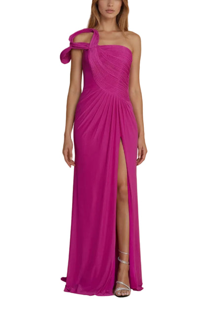 Woman wearing a vibrant pink one-shoulder gown with a slit on a beige background