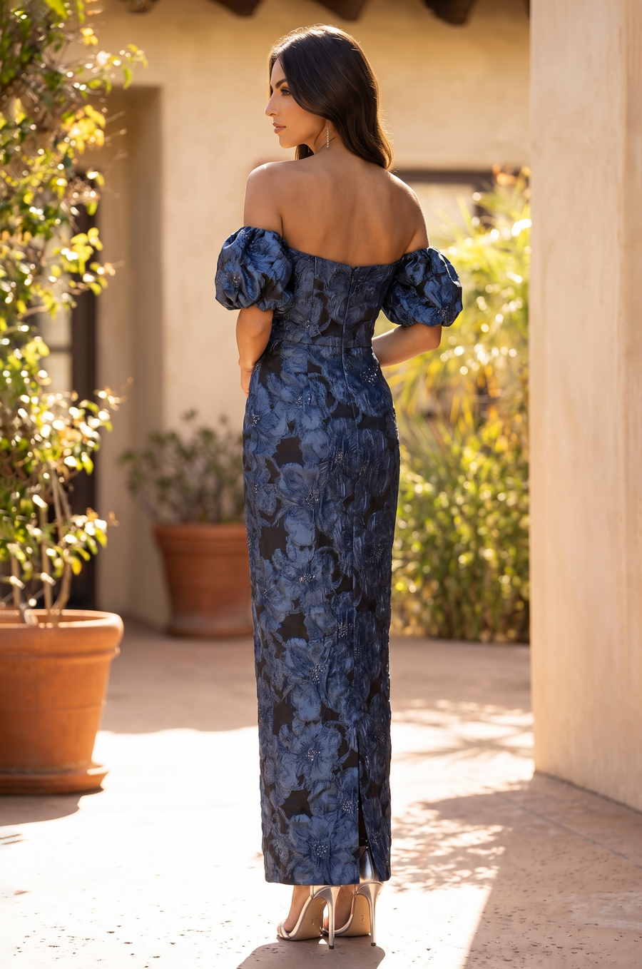 Full-length back view of the blue floral jacquard gown worn by a model.