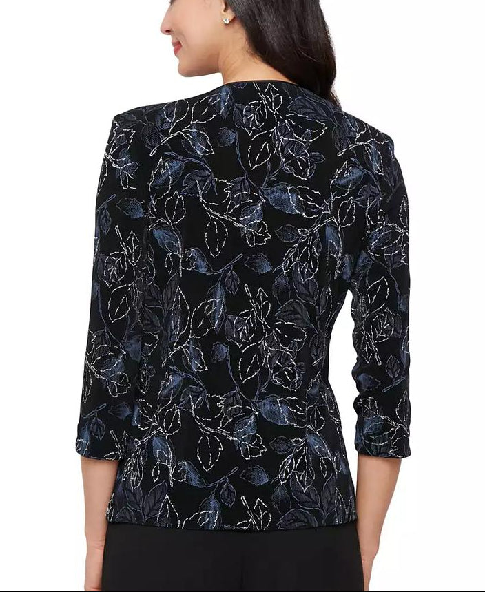 Woman wearing a black floral patterned top on a white background