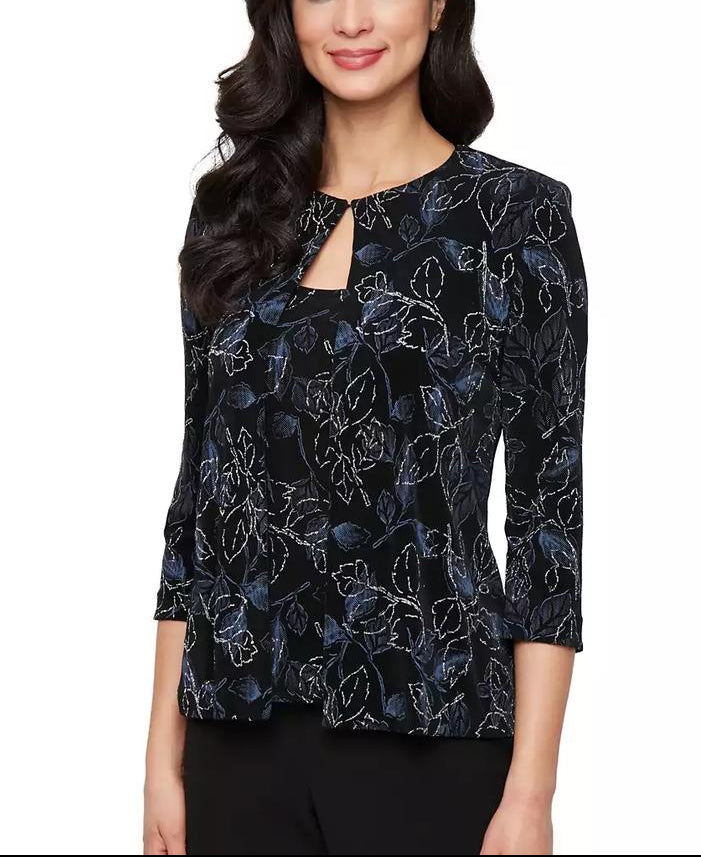 Woman wearing a black floral patterned blouse on a white background
