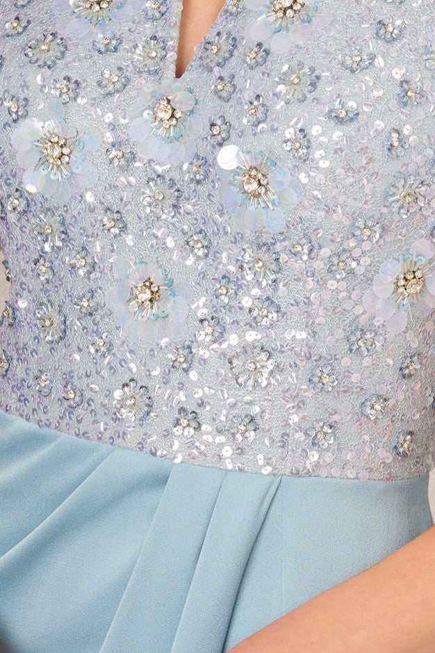 Close-up of a light blue dress with floral sequin details
