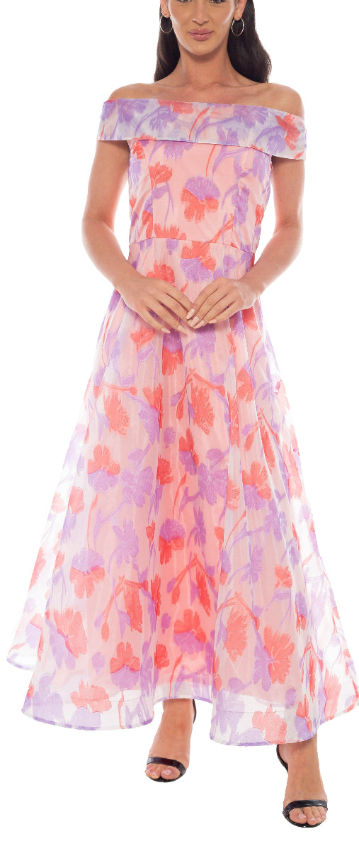 Woman wearing a colorful floral off-shoulder dress on a white background