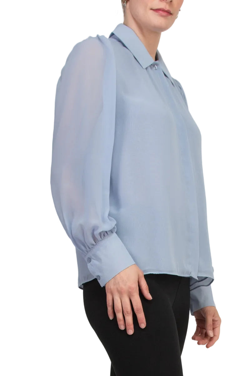 Light blue blouse worn by a person on a white background