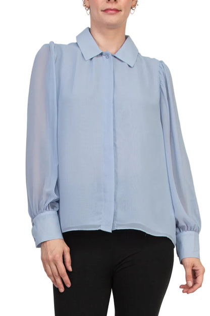 Light blue blouse worn by a person on a plain background