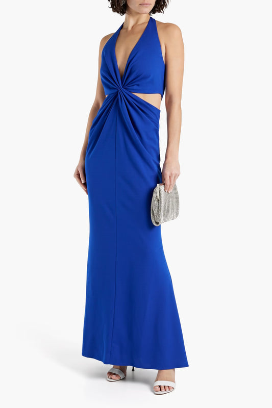 Woman wearing a blue evening gown with cutout design on a white background